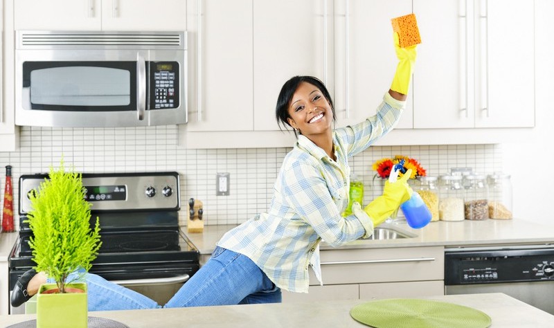 young woman sprucing up her kitchen