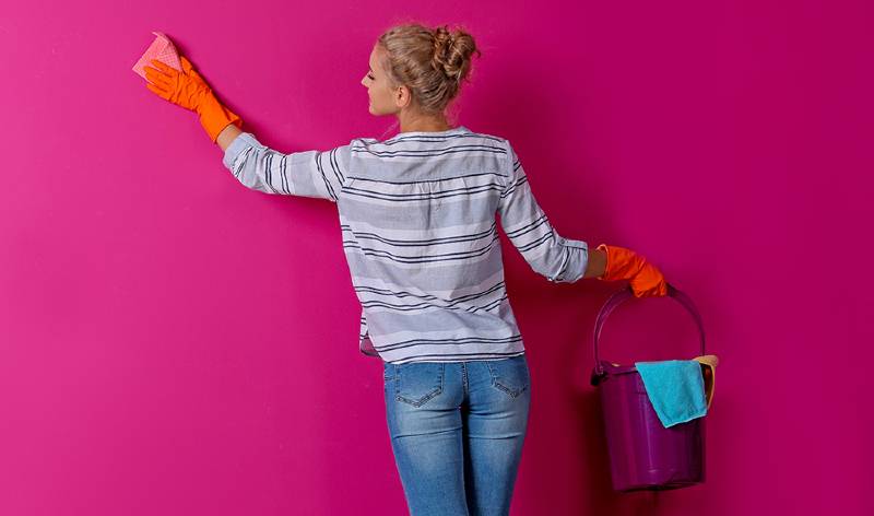 Women cleaning wall
