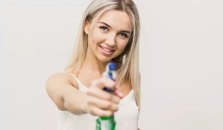 woman with a cleaning spray posing for a picture
