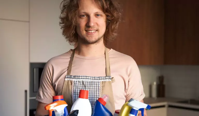 young man with a cleaning caddy