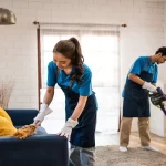 Young man and woman cleaning in living room