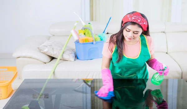Beautiful asian woman wiping and cleaning a table