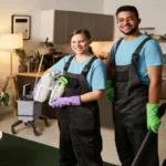 Colleagues doing cleaning in team in apartment