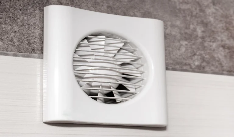 The fan is built into the wall in the kitchen