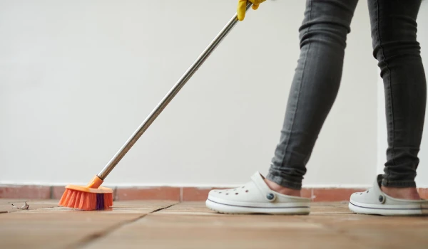 Cleaner sweeping the floor