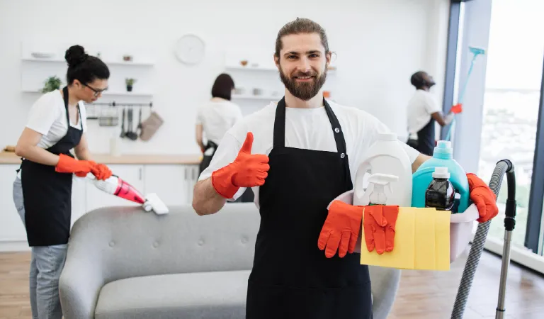 Portrait of bearded caucasian man cleaning worker holding bucket with detergents