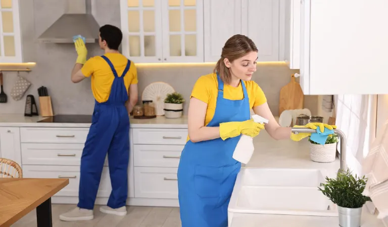 Professional janitors working in kitchen cleaning service