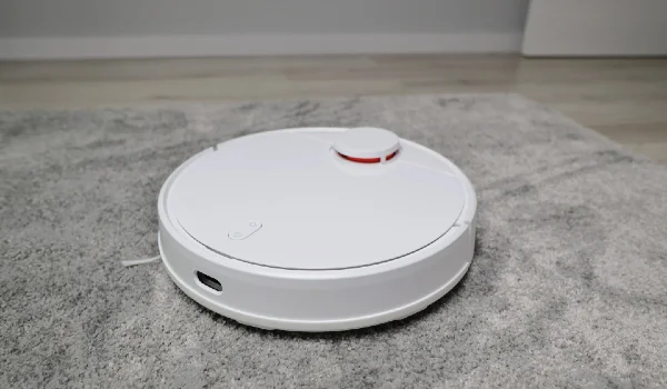 Robotic vacuum cleaner working on carpet top view concept smart electronic housekeeping technology