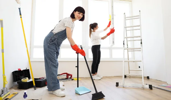 Young beautiful women cleaning up new apartment after renovation